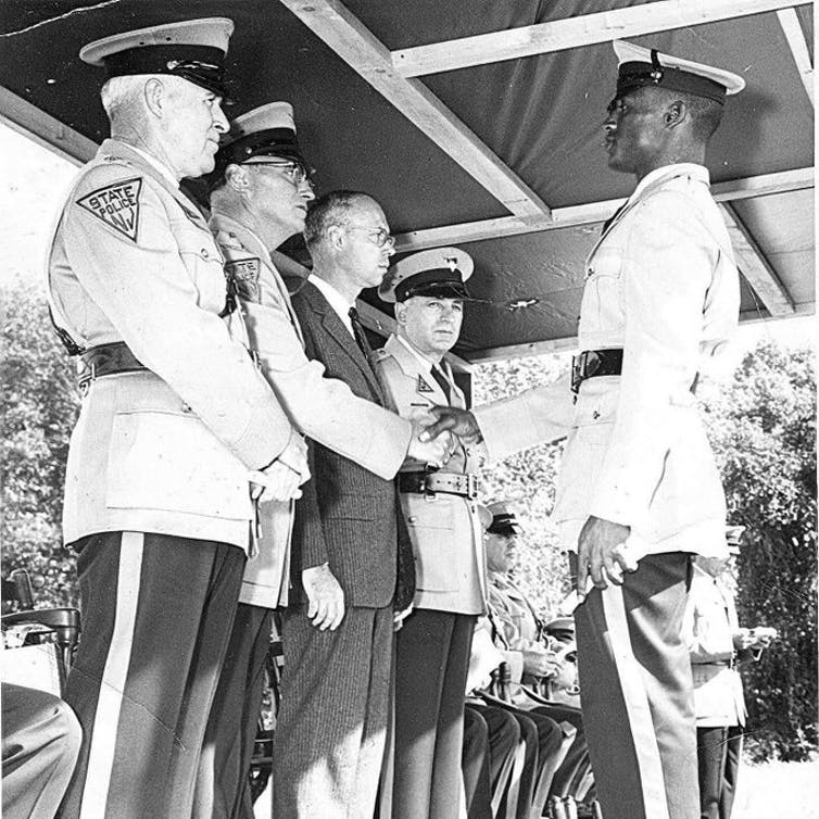 A Black man graduating from the New Jersey state police academy