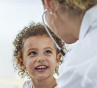 Young child smiling at doctor