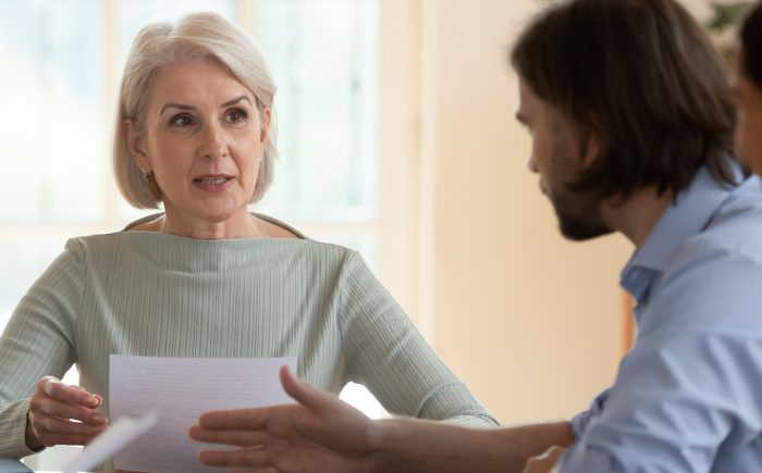 Mature woman discussing her will with her son