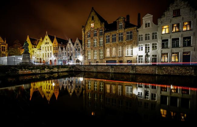 View of lake and buildings at night in Bruges, Belgium