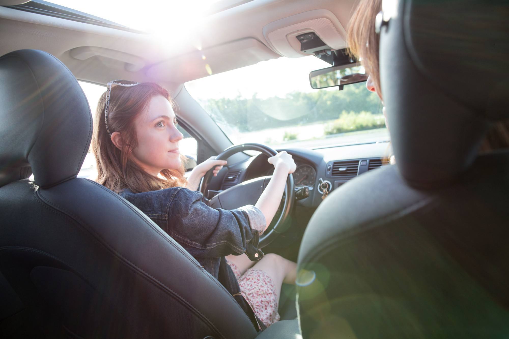 woman sitting in driver’s seat of a car