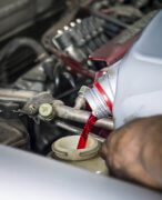 Hand pouring transmission fluid as for the good car maintenance