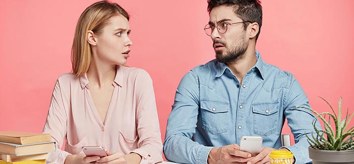 Young couple looking at each other thoughtfully for Quotacy blog 18 Questions to Ask When Getting Term Life Insurance Quotes