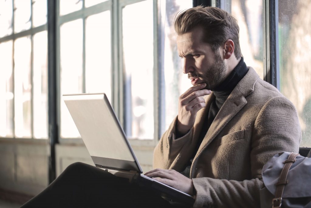 man searching online for health insurance