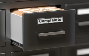 Complaints files and documents in cabinet in office. 3D rendered illustration.