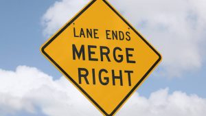 Just do the zipper merge, for the sake of all things holy