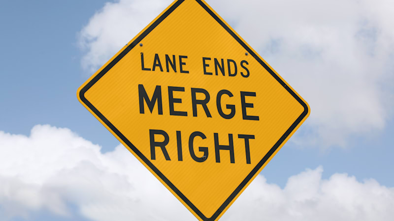 Just do the zipper merge, for the sake of all things holy