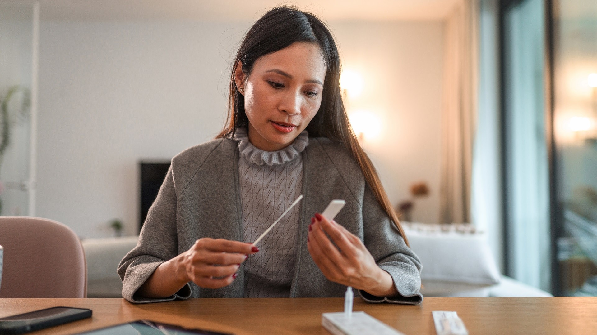 Asian Woman Holding Covid Rapid Test And Waiting For Results stock photo