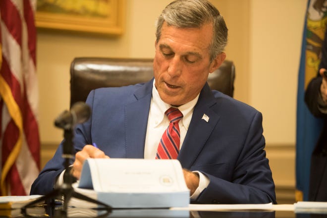 Gov. John Carney signs the budget bill on June 30, 2021.