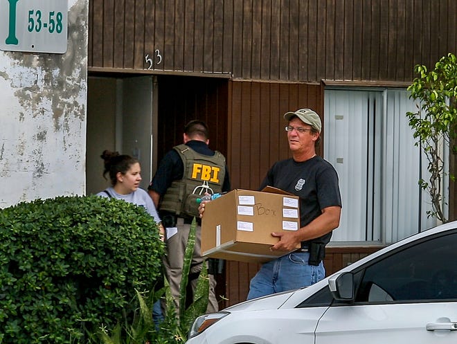 Federal agents remove evidence from an office at the Green Terrace condominium, where the condos have been converted to a sober living home, September11, 2014, in West Palm Beach. The raid led to the closure of Good Decisions Sober Living and later to the convictions of Kenneth Bailynson and Dr. Mark Agresti in a $31.3 million heath care fraud scheme.