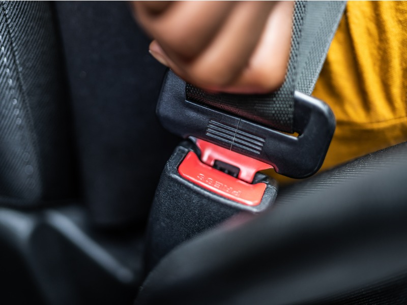 woman buckling seatbelt