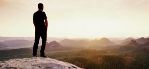 man thinking overlooking nature for Quotacy blog making a big decision