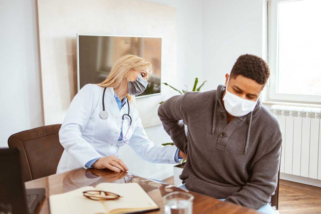 A young man in kidney pain is examined by his physician