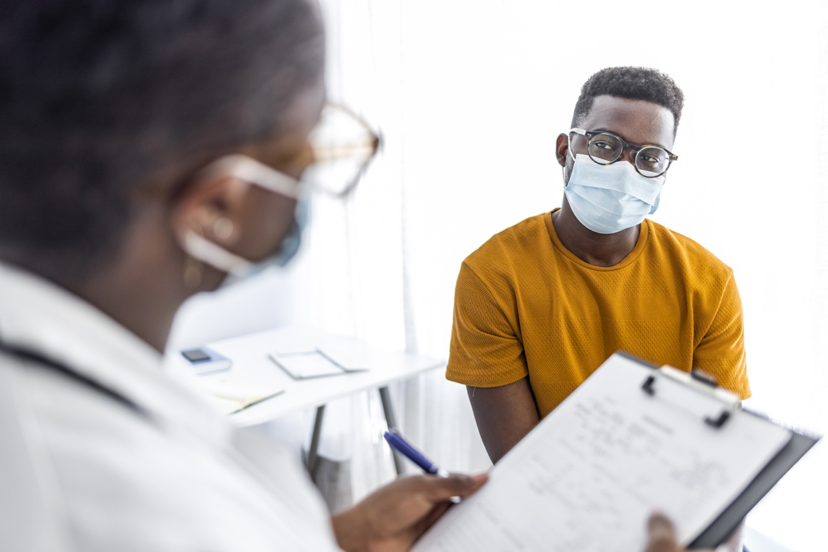 A man listens, as his doctor explains the colonoscopy procedure