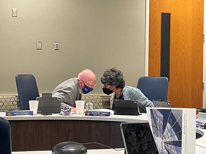 Cumberland County commissioners Larry Lancaster (left) and Jeannette Council (right) hold a discussion on the side during an agenda session meeting on Thursday that showed high health care expenses for the county due to its employees.