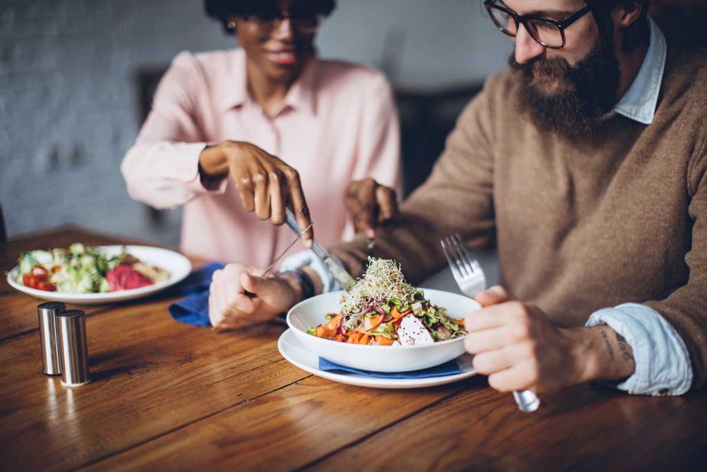 Happy couple having healthy vegetarian dinner