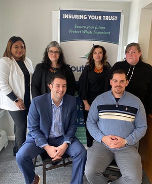 Southcoast Insurance Group owner Nick Daddona (seated at left) with some of his staff members. Back row, left to right: Dayann Dominguez, Niz Sousa, Lisa Souza, and Nicole Campbell. Front row: Daddona and Brian Cardeiro.