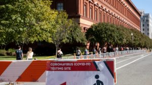 people form a line outside a building in Washington, D.C in order to get tested for COVID-19