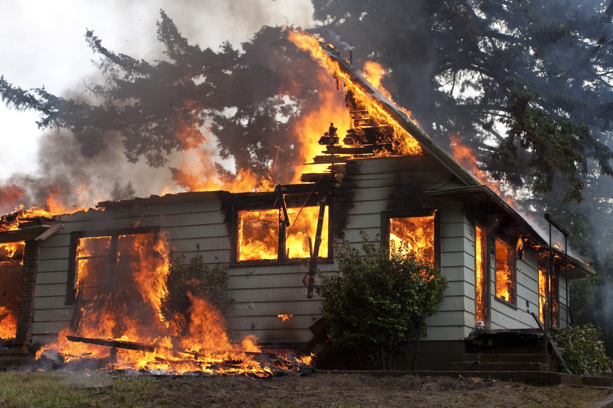 Rural family home fully engulfed in flames.