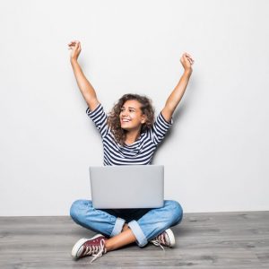 Happy young woman with laptop