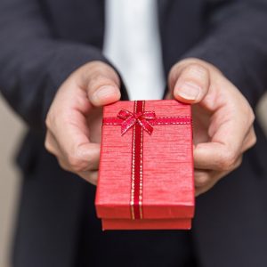 Businessman holding gift