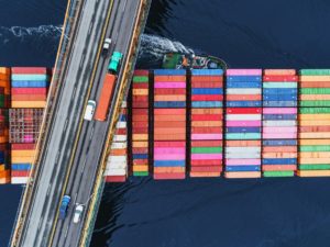 A container ship passes beneath a suspension bridge as it departs for Europe.