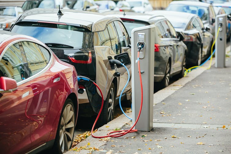 Electric vehicles charging on the street