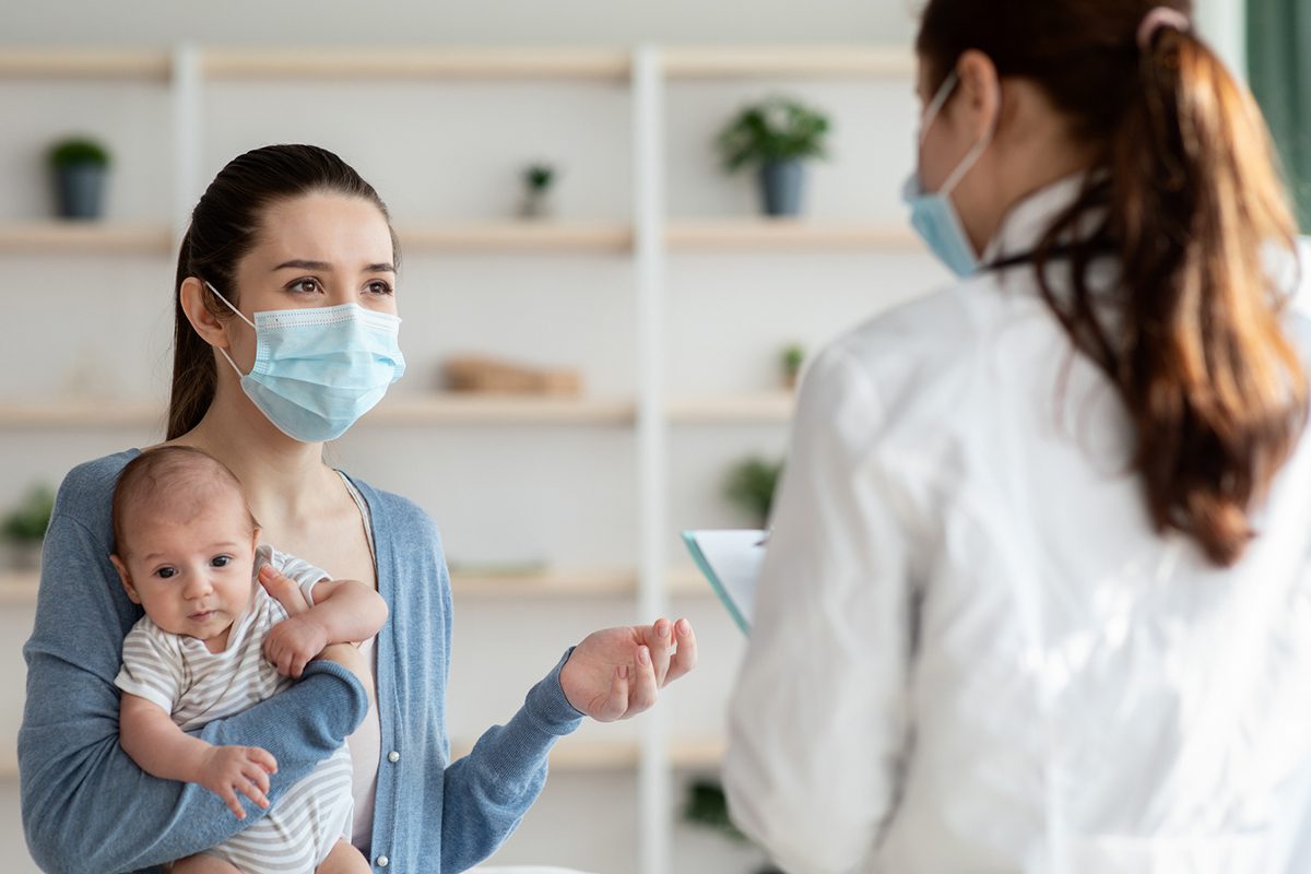 A mother with infant talks to her physician