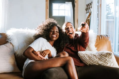 happy couple watching TV