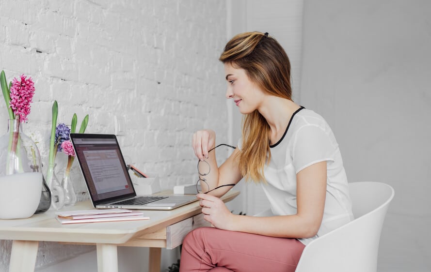 Woman sitting at her desk doing research on the computer