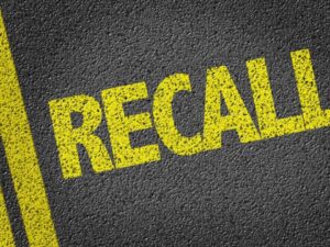 Recall painted in yellow on a roadway to represent an auto recall