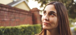 Image of woman looking thoughtful for Quotacy blog: Is Term Life Insurance Better than Whole Life Insurance.