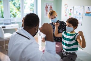 A pediatrician having a check up on his patient