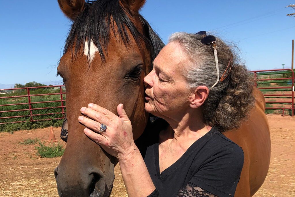 A photo shows Suzanne BeHanna standing with a horse.