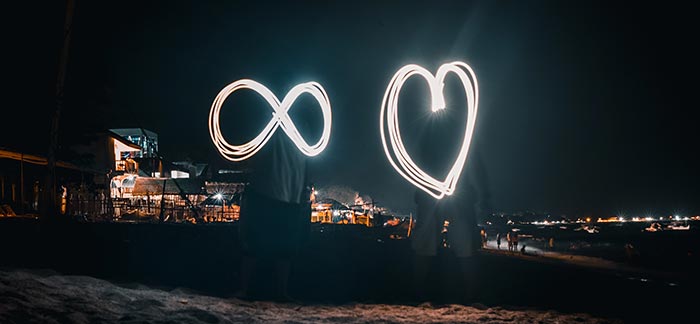 infinity symbol and heart made with sparklers for Quotacy blog What Is Guaranteed Universal Life Insurance?