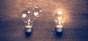 a broken light bulb next to a working one for Quotacy blog Is Permanent Life Insurance a Bad Idea for Me?