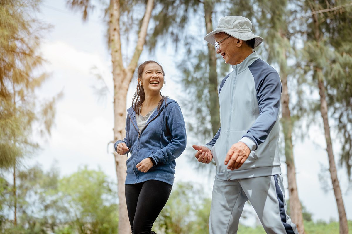 A young woman and her grandfather enjoy a low intensity walk together