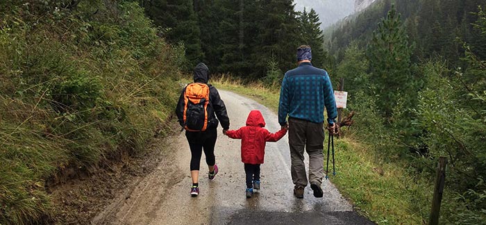 Image of family hiking down a mountain path for Quotacy blog What You Need to Know About Life Insurance