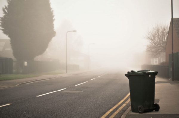 Misty road with bin in foreground