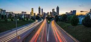 Image of red & white headlights from cars on a freeway in a metro cityscape for Quotacy blog Accelerated Death Benefit Rider