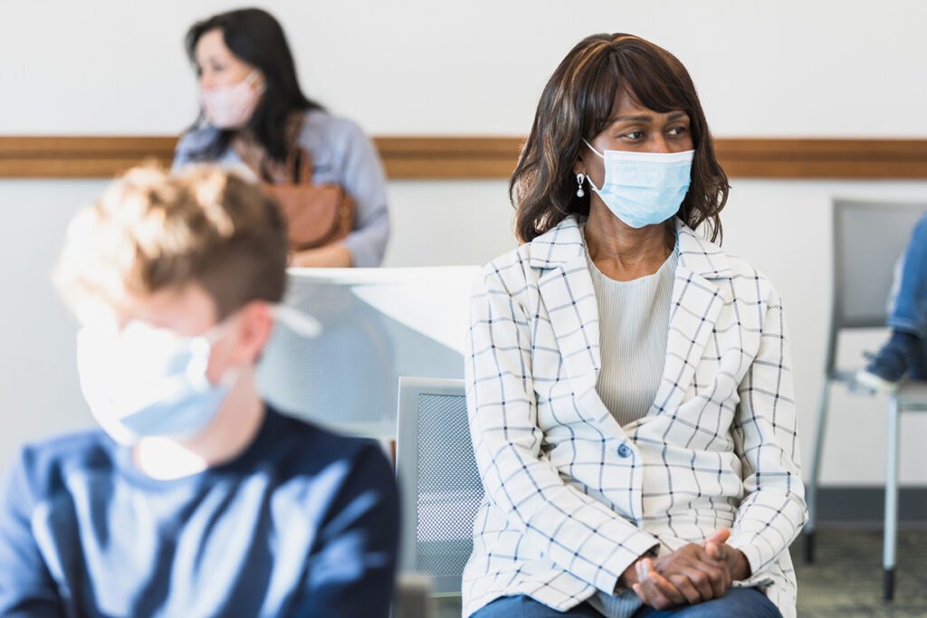 A woman sits in her doctor's waiting room before her breast cancer screening