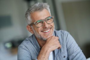 Wealthy older man with glasses smiling