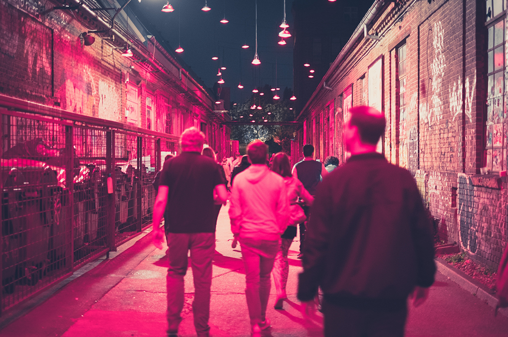 a group of students walking down a street at night