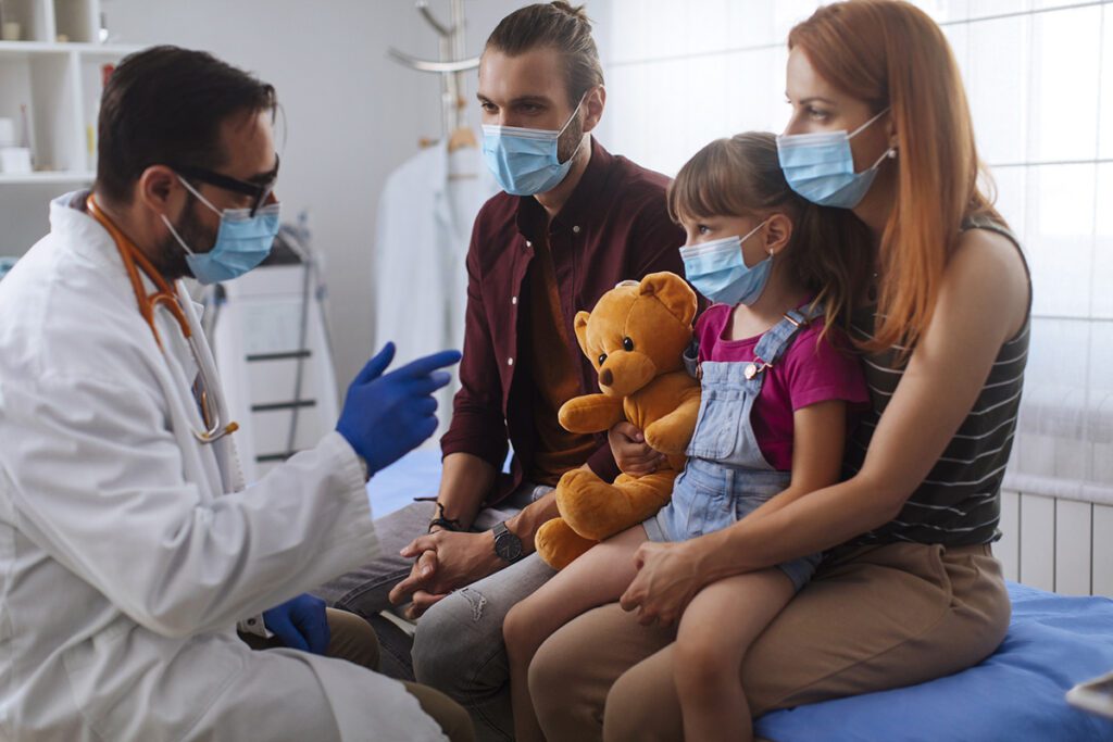 A young girl and her parents talk to the doctor.
