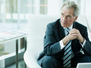 Older businessman looking worried about getting fired