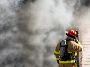 Firefighter putting out a house fire