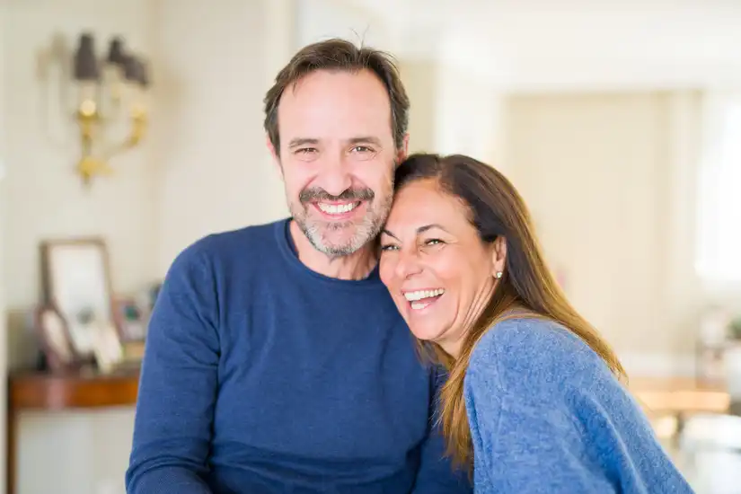 Couple hugging each other and smiling