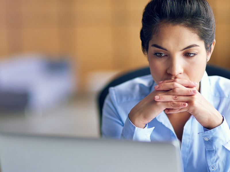 Worker reflecting at her desk