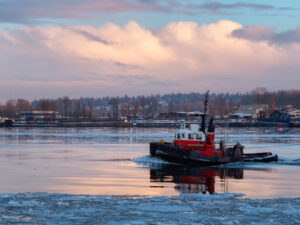 Industrial tugboat pulling a load in Fraser River