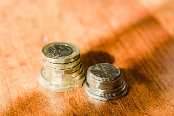 Money stacked up on wooden table